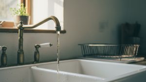 Running well water with sulfur odor at a farmhouse kitchen faucet
